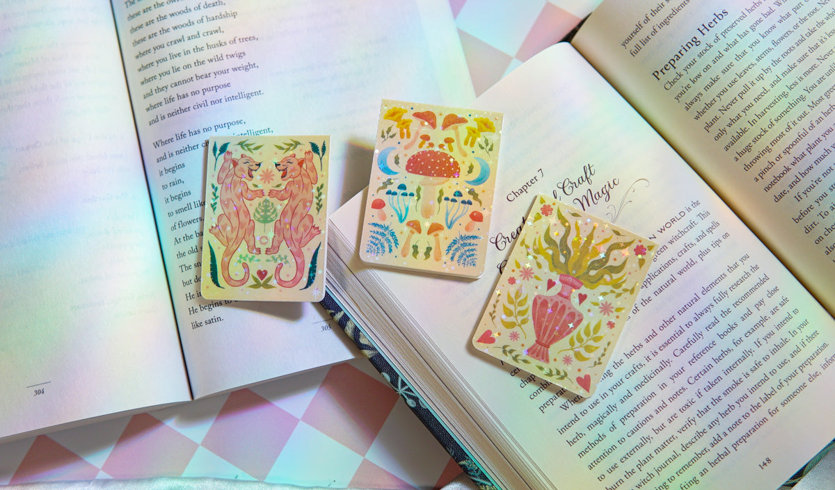 Books covered in a a few bookmarks, rainbow light shining on top